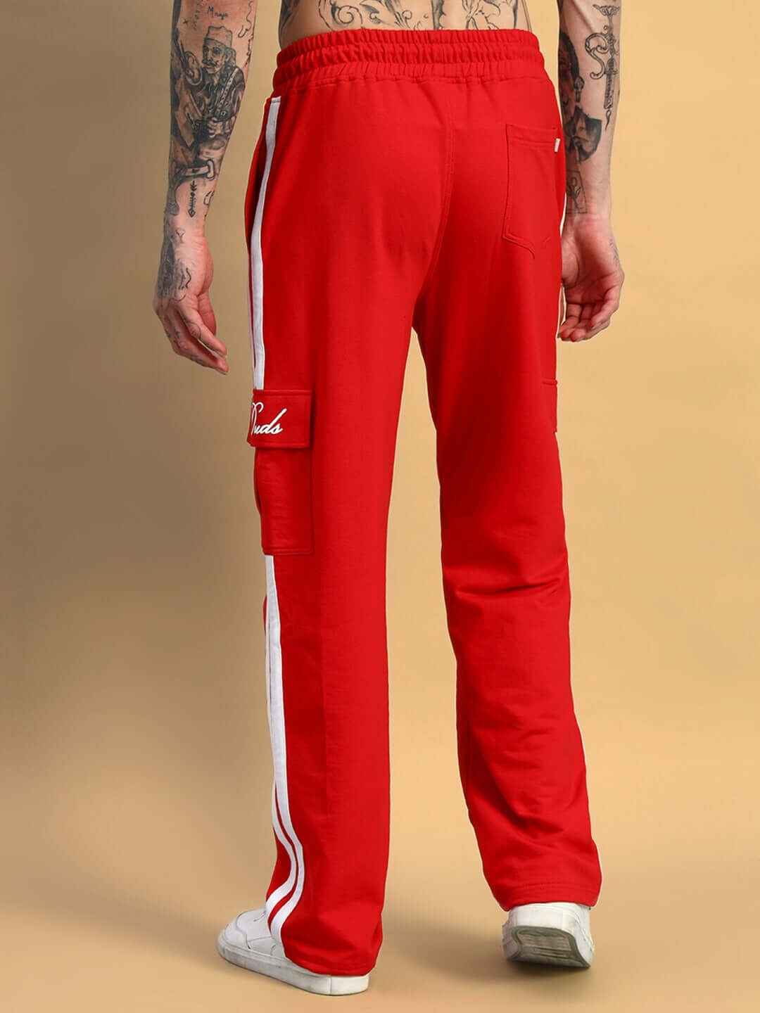 Back view of red Scotia Stripe Joggers from DUDS, featuring white side stripes and relaxed fit ideal for customized sizing.