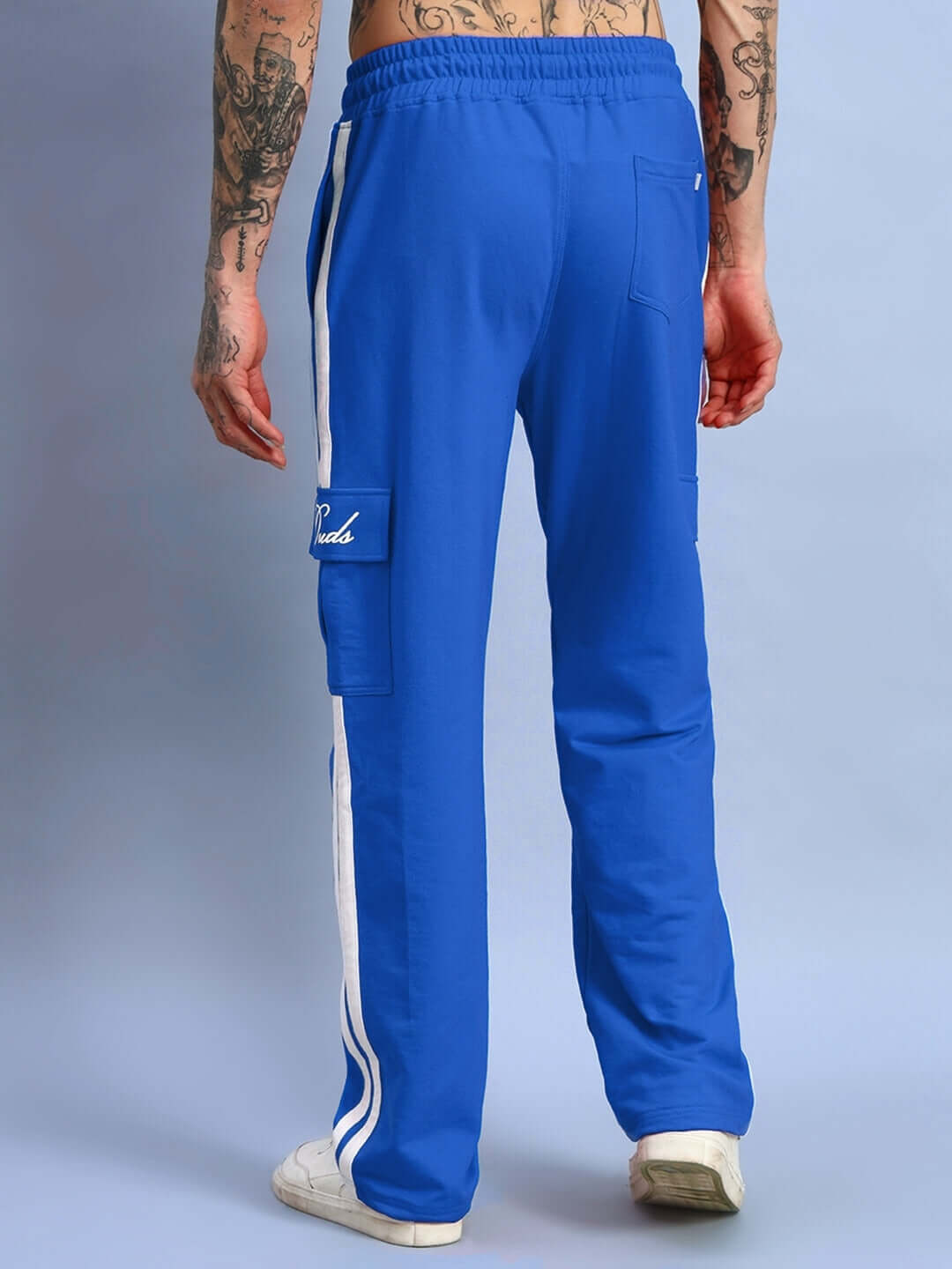 Back view of royal blue Scotia Stripe joggers with white side stripes, highlighting unique design and tailored craftsmanship.