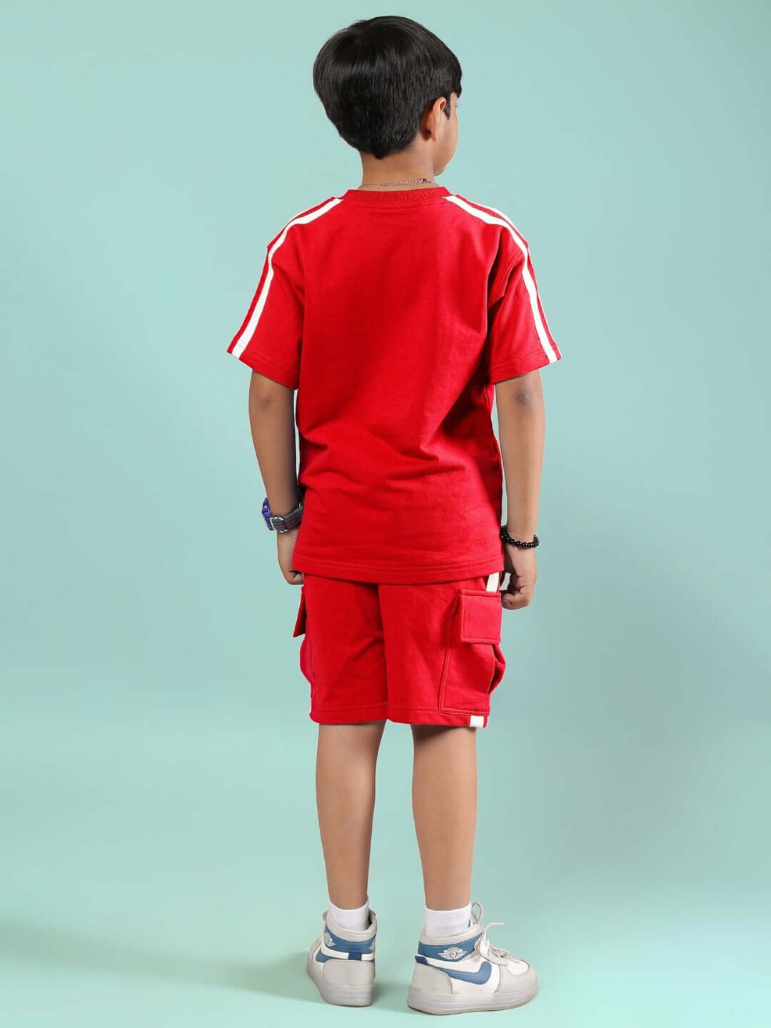 Child wearing SCOTIA SUMMER CO-ORD FOR BOYS & GIRLS RED set, showcasing back design and vibrant color.