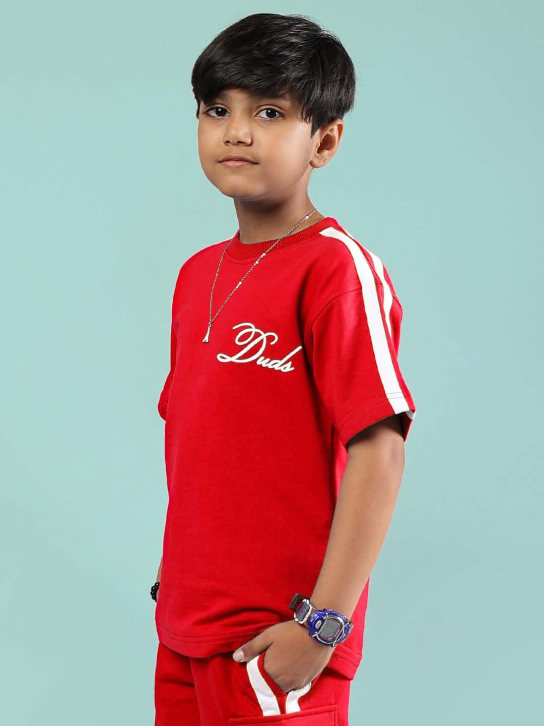 Boy wearing SCOTIA T-SHIRT FOR BOYS & GIRLS RED by Duds with white stripes and logo.