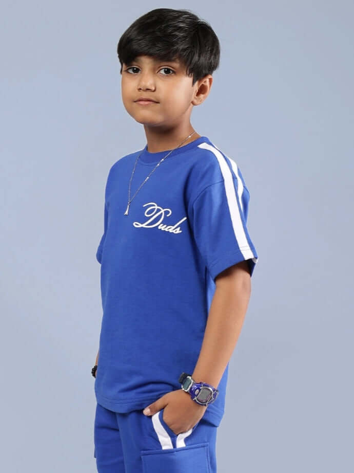 Young boy wearing Scotia T-Shirt for Boys & Girls in Royal Blue, soft cotton, side view, casual and stylish attire.