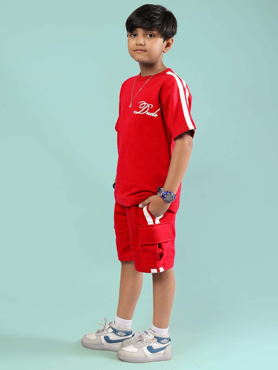 Child wearing Scotia Summer Co-Ord for Boys & Girls Red, showcasing a stylish and comfortable red outfit perfect for summer activities.