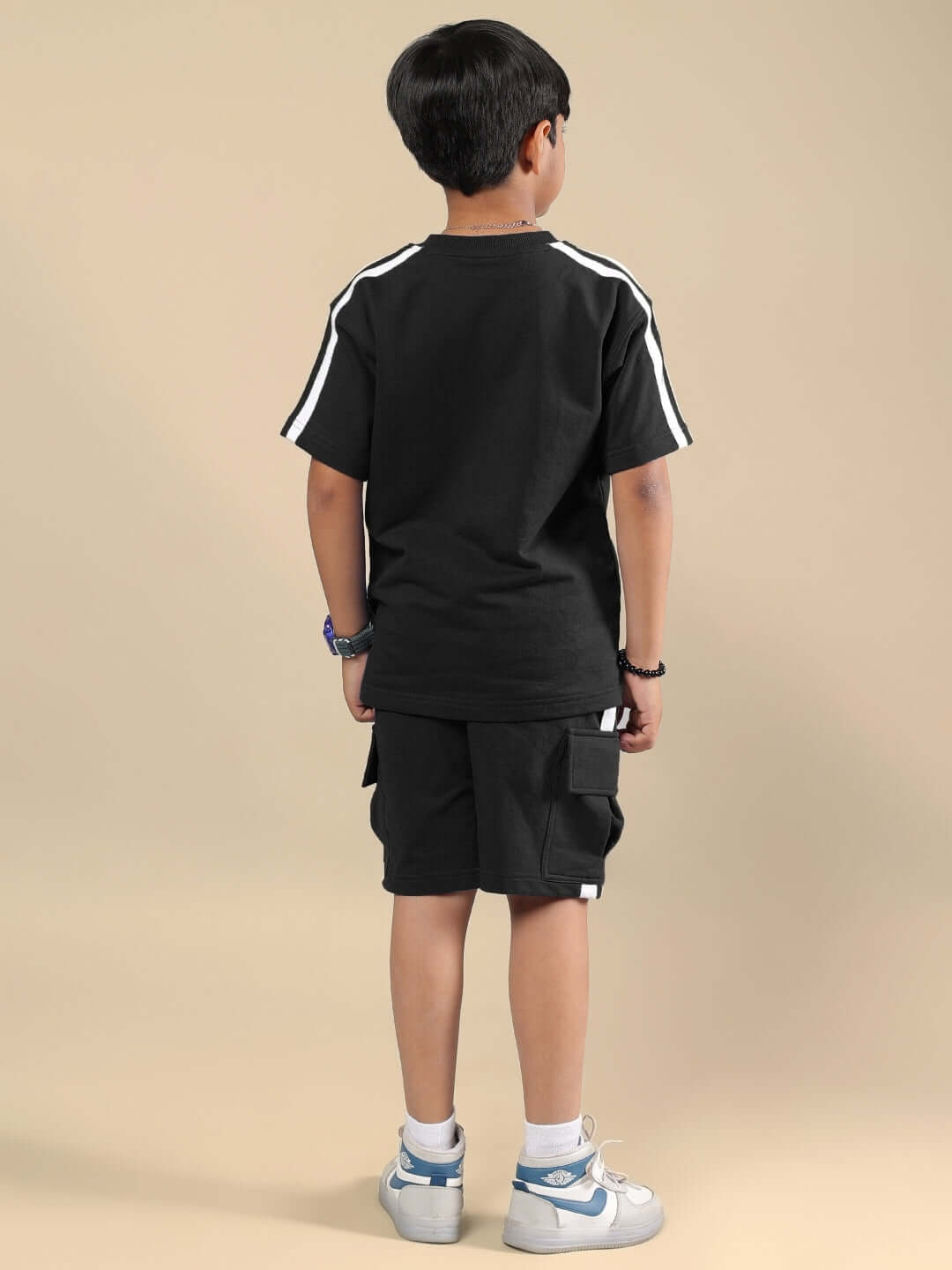 Child wearing SCOTIA SUMMER CO-ORD FOR BOYS & GIRLS BLACK, back view. Comfortable and stylish made-to-order clothing.
