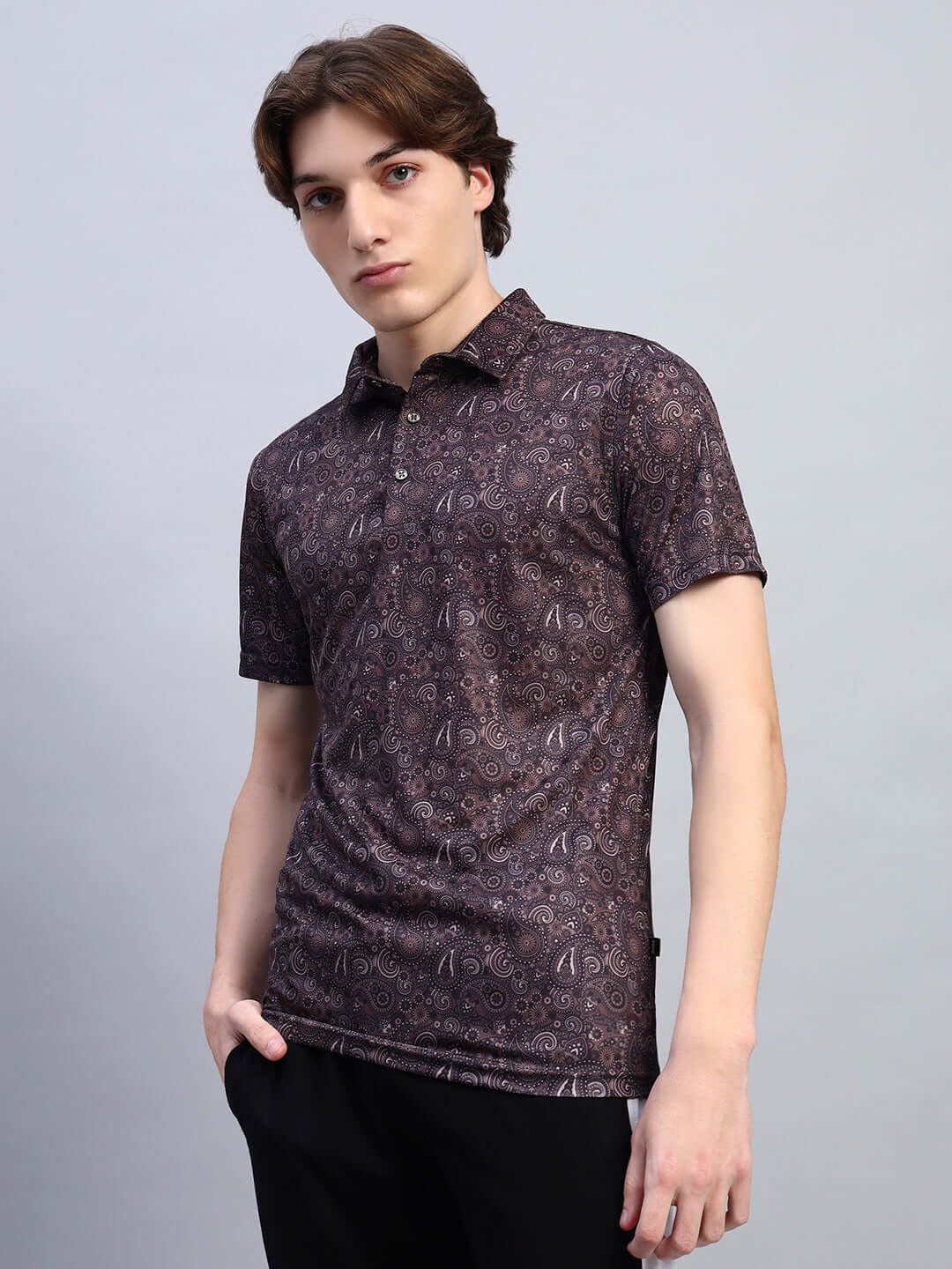 Model wearing Scottish Regular Fit T-Shirt in brown sports polyester, featuring a subtle paisley pattern, made in India.
