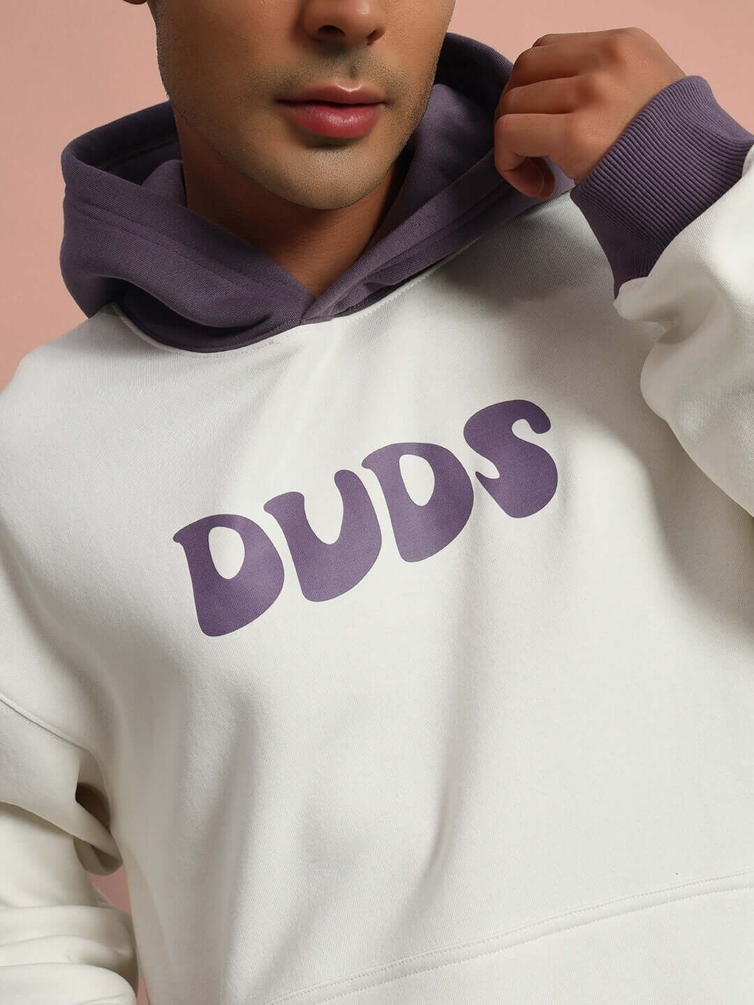 Model wearing SELF LOVE FLEECE CO-ORD WHITE VIOLET hoodie showing "DUDS" text design.