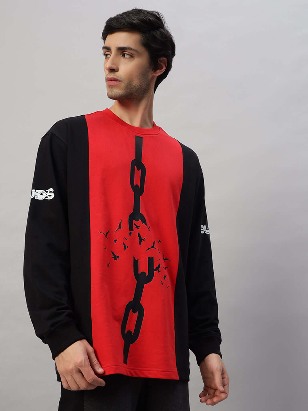 Model wearing SELF-RULE oversized black and red sweatshirt made of premium cotton, featuring a chain design on the front.