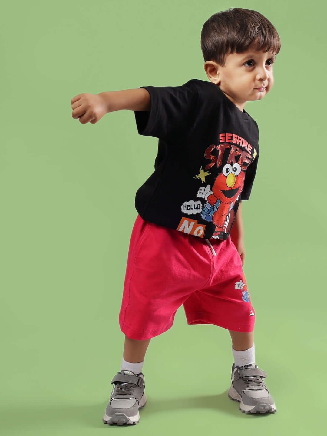 Young child wearing SESAME CO-ORD FOR BOYS & GIRLS BLACK-PINK. Vibrant outfit featuring black top and pink shorts, suitable for kids.