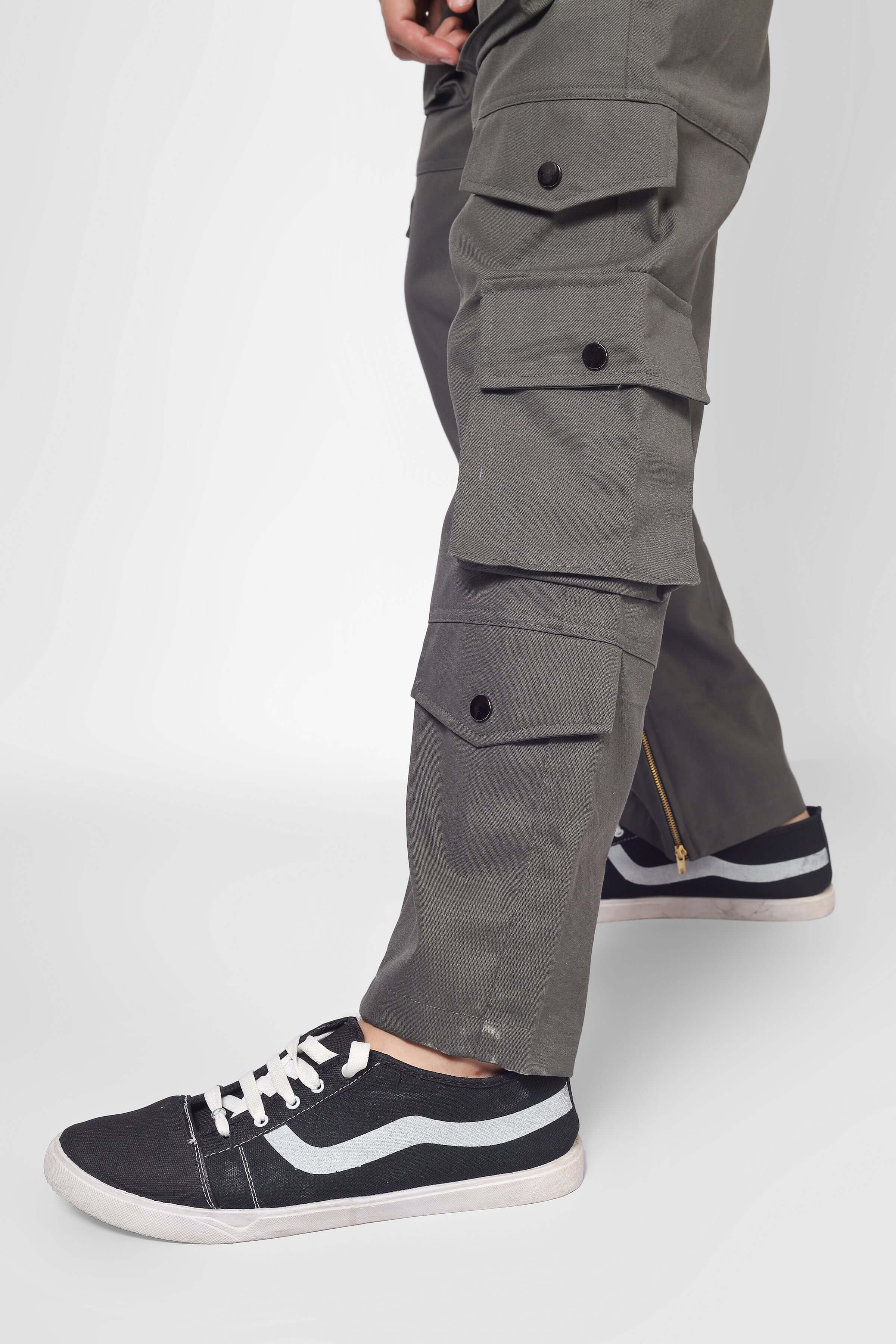 Model wearing shadow grey cargo pants with 8 pockets, showcasing durable design and comfortable fit.