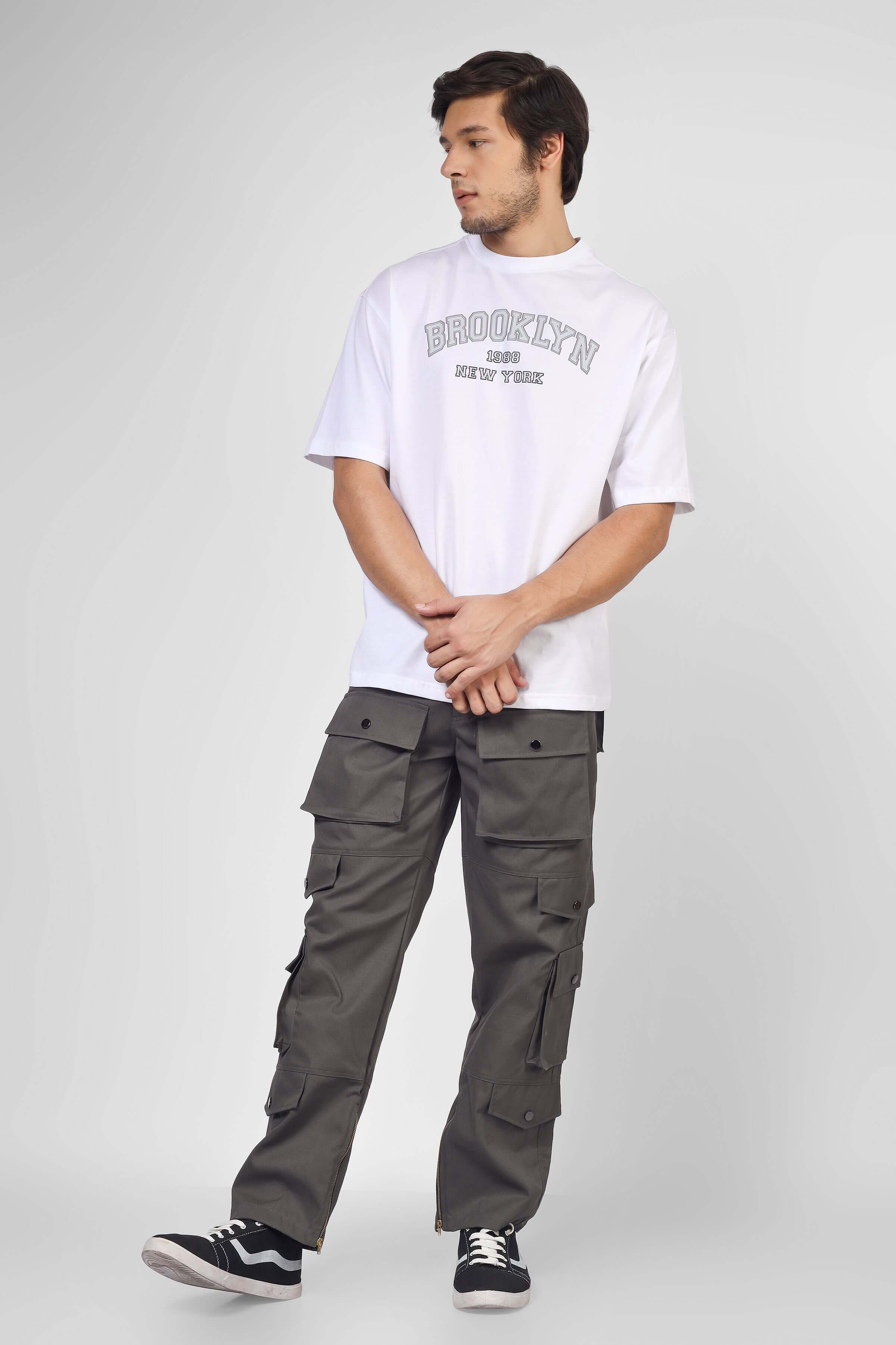 Model wearing shadow grey cargo pants with 8 pockets and a white graphic tee.