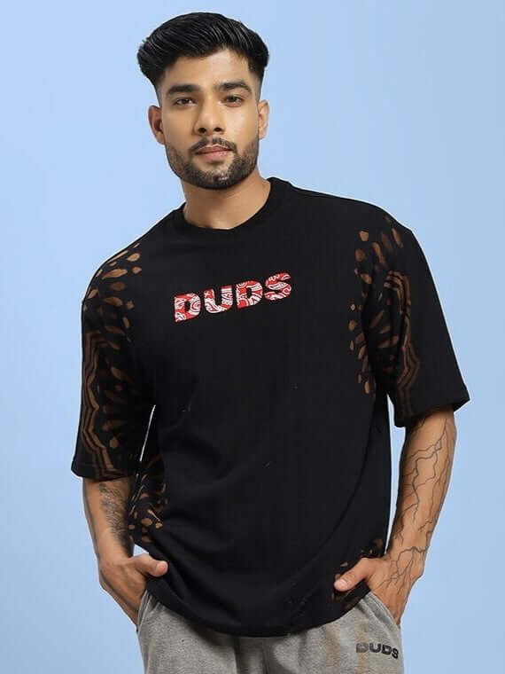 Model wearing SHADOW SWIRL TIE-DYE T-SHIRT BLACK with unique tie-dye pattern, perfect for casual style and comfort.