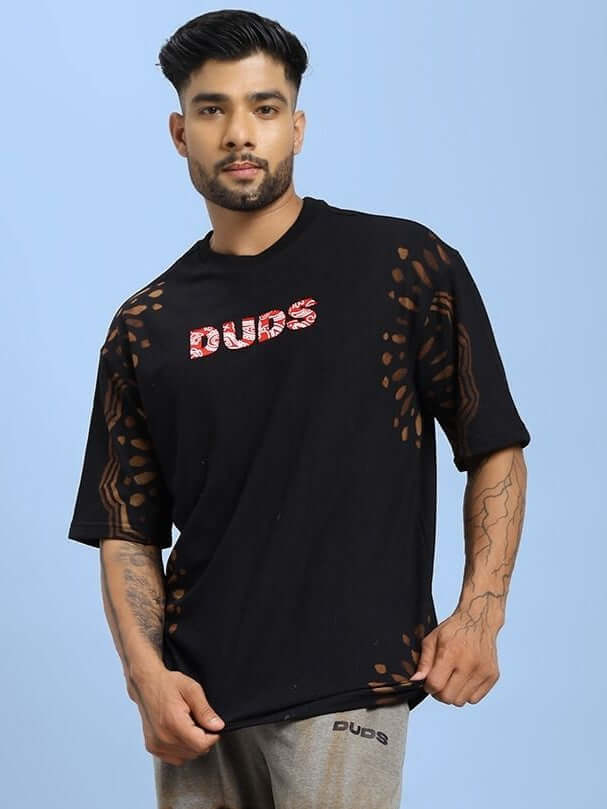 Man wearing a black SHADOW SWIRL TIE-DYE T-SHIRT BLACK with subtle patterns.