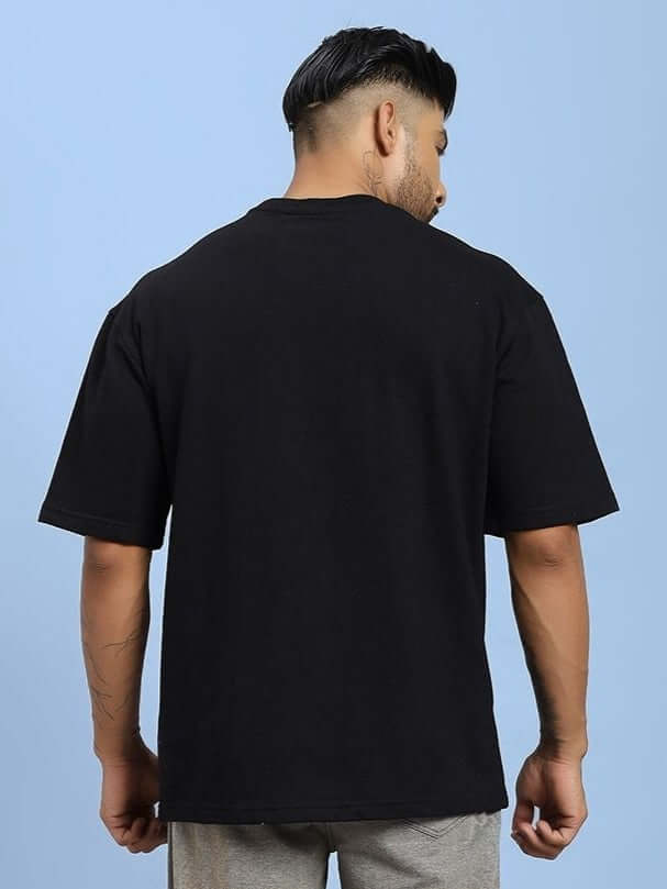 Back view of SHADOW SWIRL TIE-DYE T-SHIRT BLACK on model, showcasing casual style and premium cotton comfort for everyday wear.