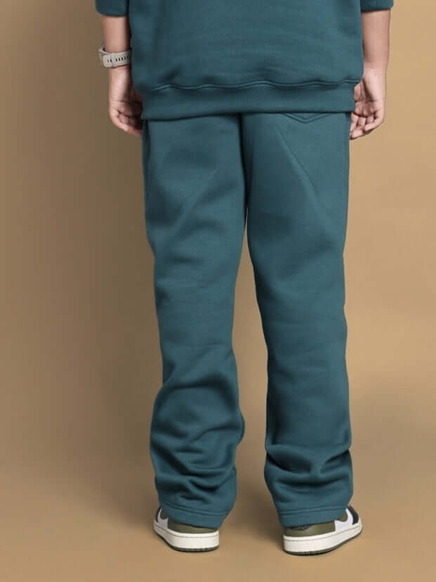 Back view of teal green Shaggy fleece jogger pants for kids, showcasing soft fabric and comfortable fit.