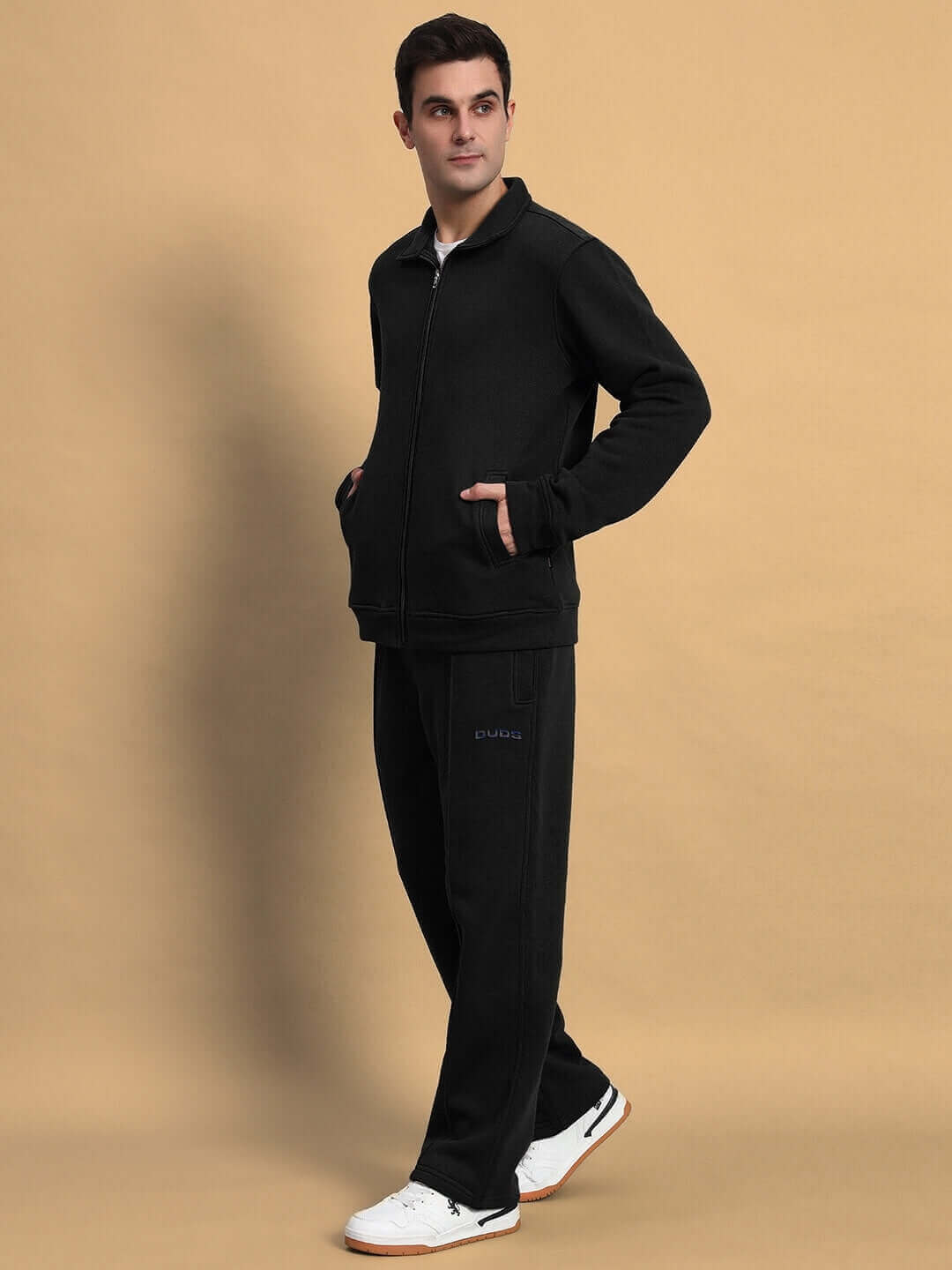 Man wearing SHAGGY ZIPPER FLEECE CO-ORD SET in black, hands in pockets, casual look.