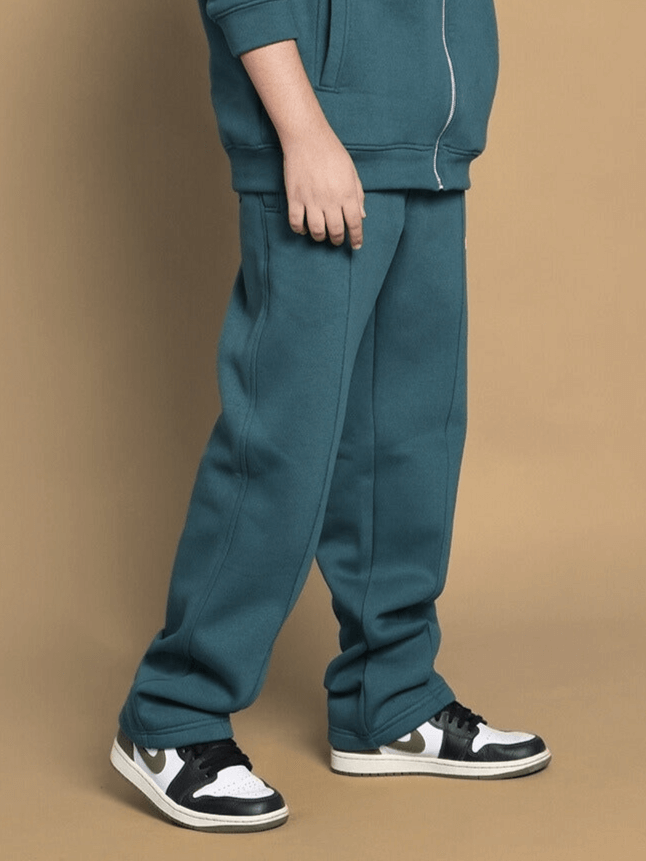 Child wearing teal green shaggy fleece jogger, showcasing comfortable fit and style for boys and girls.