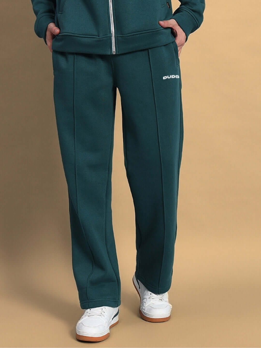 Teal green shaggy fleece jogger pants with sneakers, featuring a comfortable fit and sporty design for casual wear.