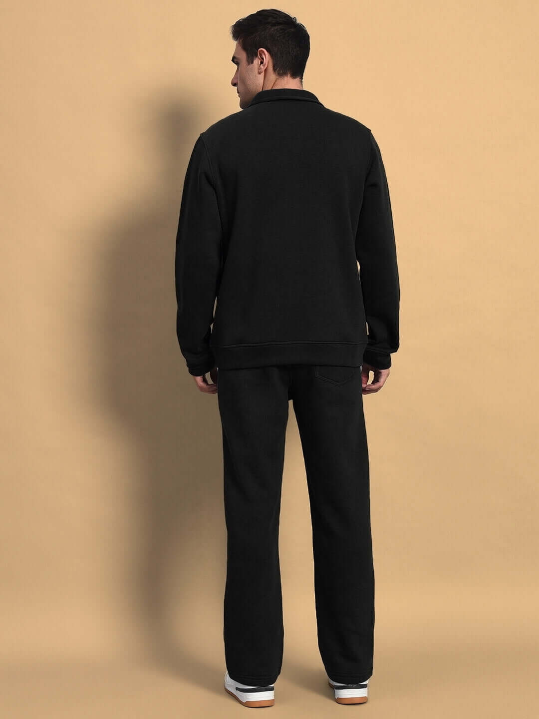 Rear view of model wearing SHAGGY ZIPPER FLEECE CO-ORD SET BLACK highlighting the comfortable fit and design.