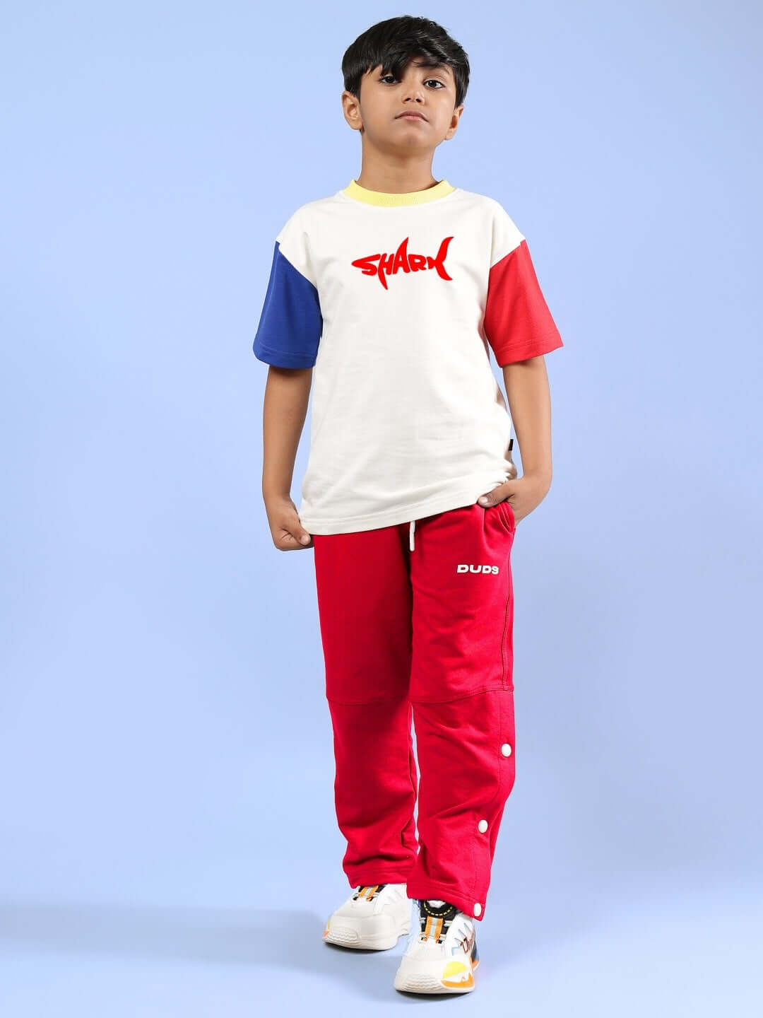 Boy wearing SHARK FISH PRINTED CO-ORD FOR BOYS & GIRLS OFF WHITE-RED, featuring off-white top and red pants by DUDS.