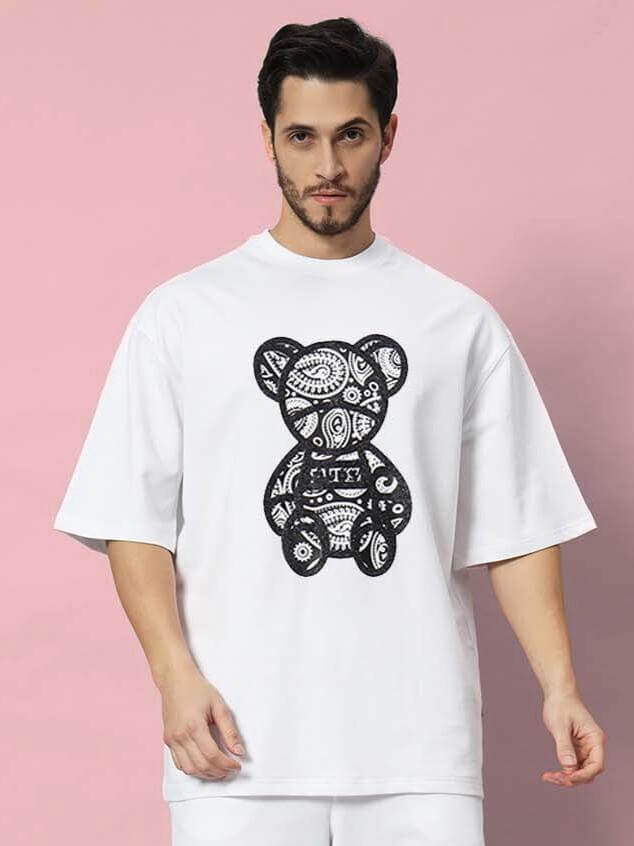 Model wearing SHIMMY oversized white T-shirt with black graphic design, made of premium cotton blend, 240 GSM, bio-washed.