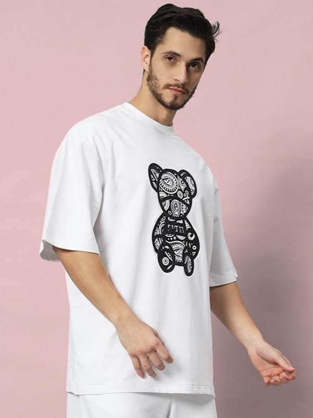 Man wearing SHIMMY over-sized white t-shirt made from premium cotton fabric with a unique graphic design.