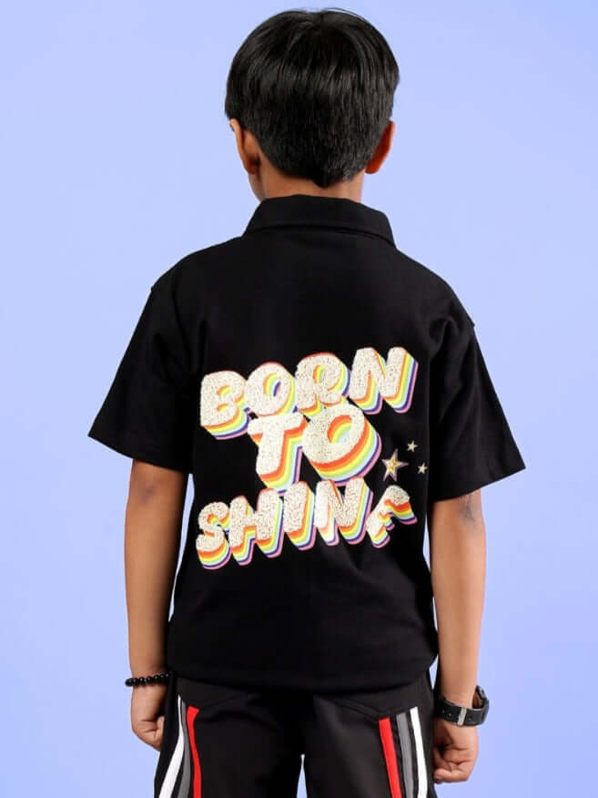 Child wearing a black Shine Shirt featuring 'Born to Shine' text, suitable for boys and girls. Custom fit available. Order now from DUDS.