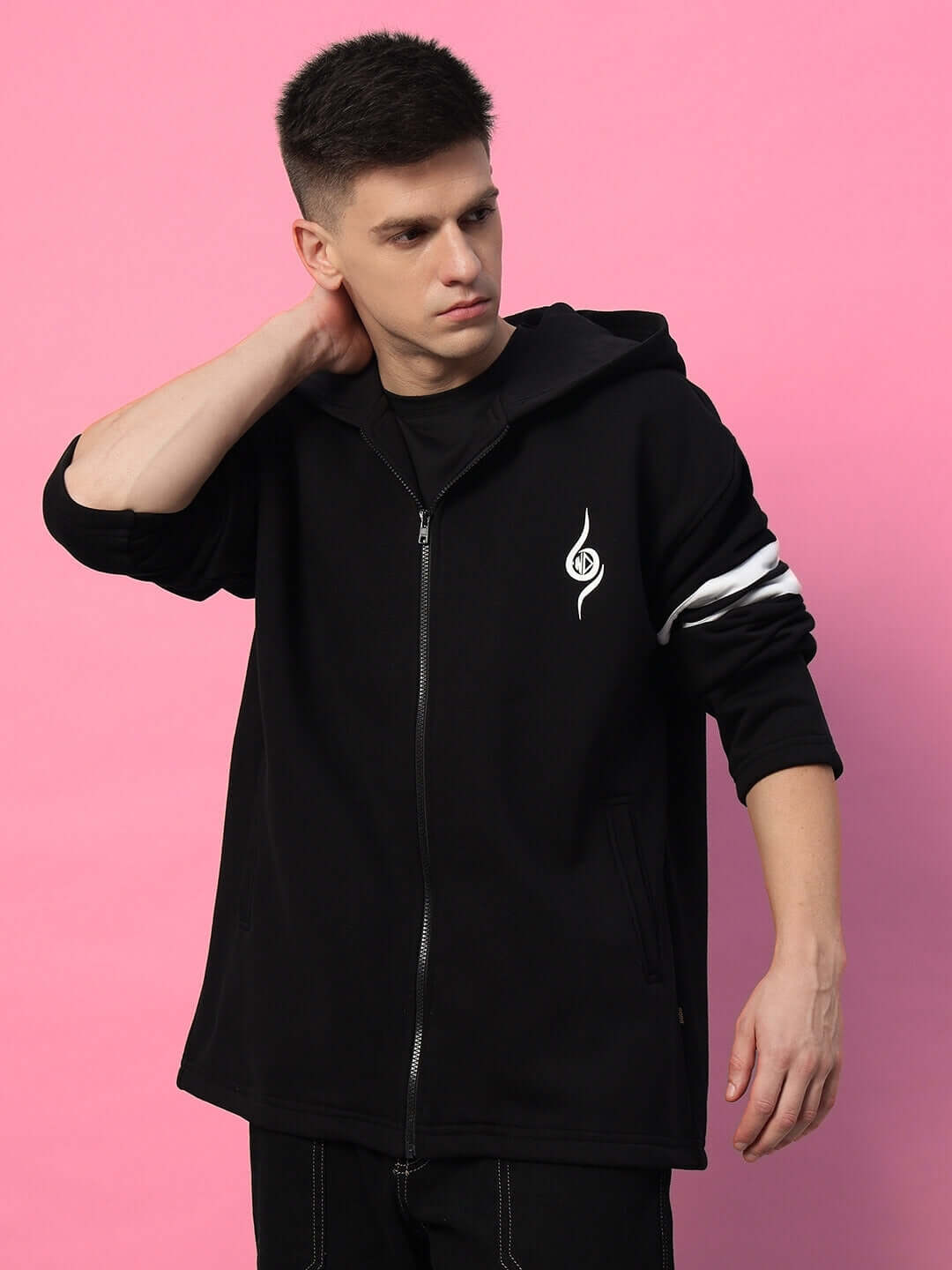 Man wearing SHINOBI ZIPPER LONG LENGTH FLEECE HOODIE BLACK against pink background