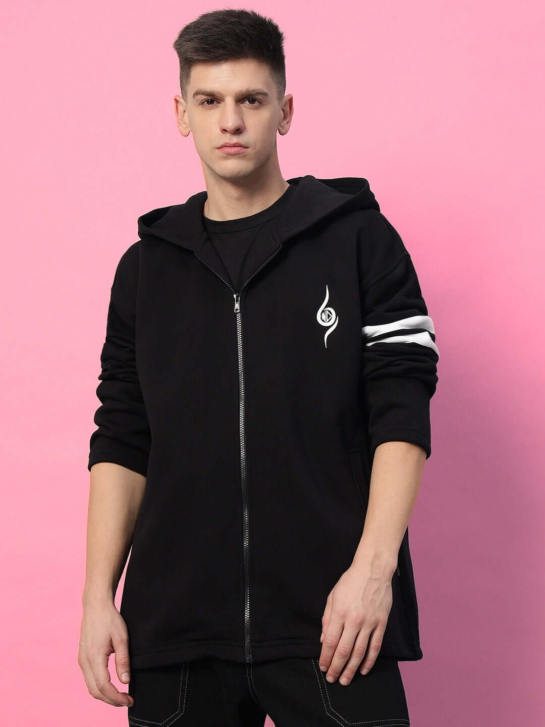 Man wearing SHINOBI ZIPPER LONG LENGTH FLEECE HOODIE BLACK against pink background