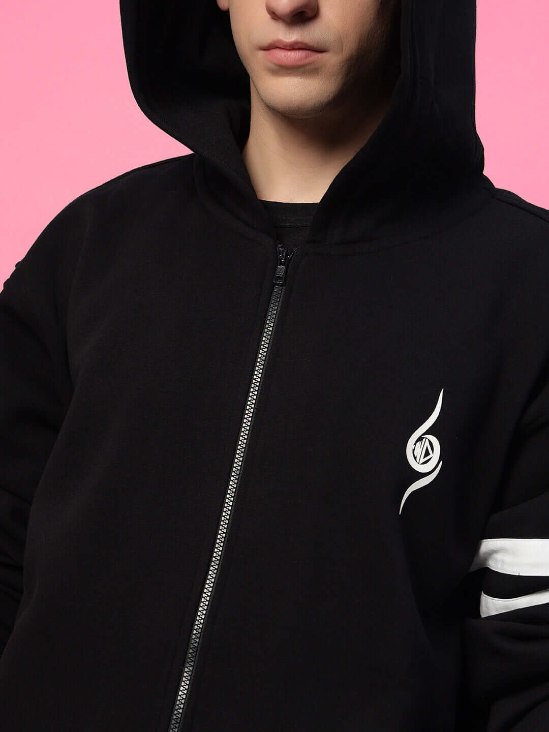 Person wearing SHINOBI ZIPPER LONG LENGTH FLEECE HOODIE BLACK against pink background