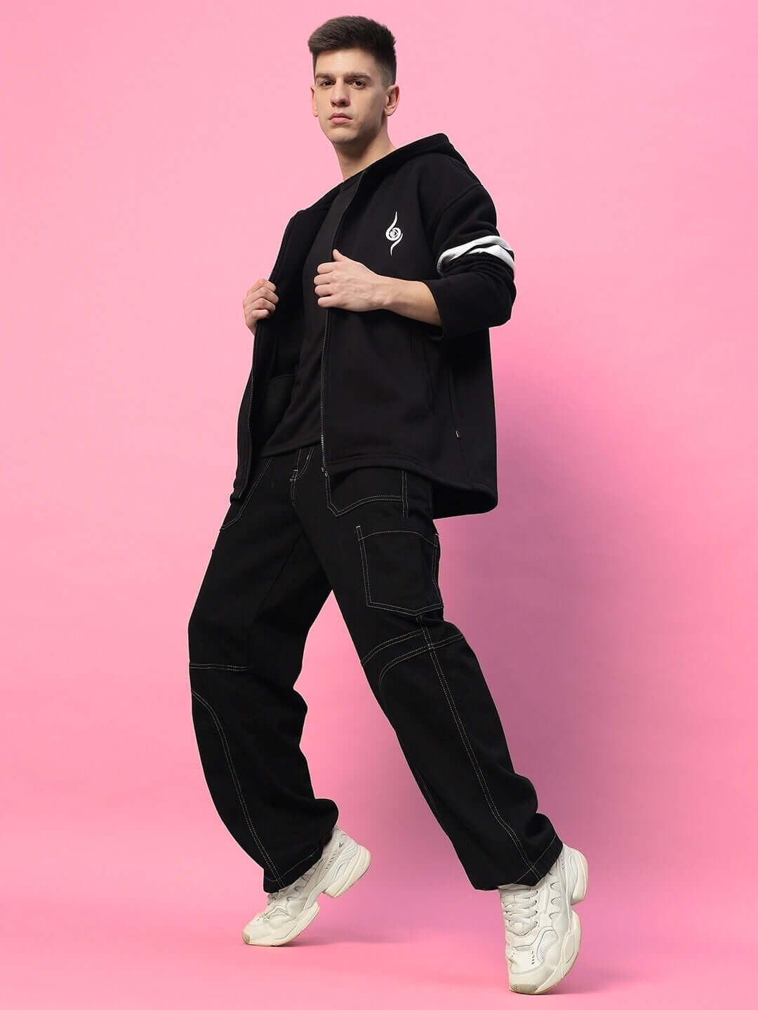 Model wearing SHINOBI ZIPPER LONG LENGTH FLEECE HOODIE BLACK with streetwear style against pink background