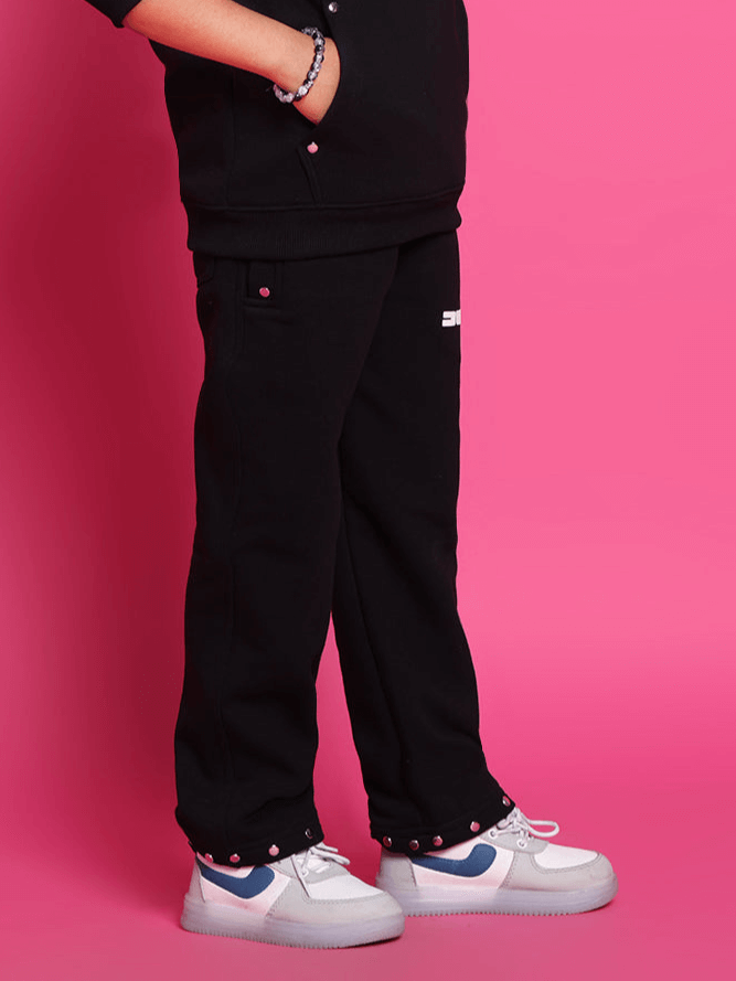 Alt Tag: Shooter fleece pant for boys and girls in black, displayed with pink background, showcasing comfortable style and fit.