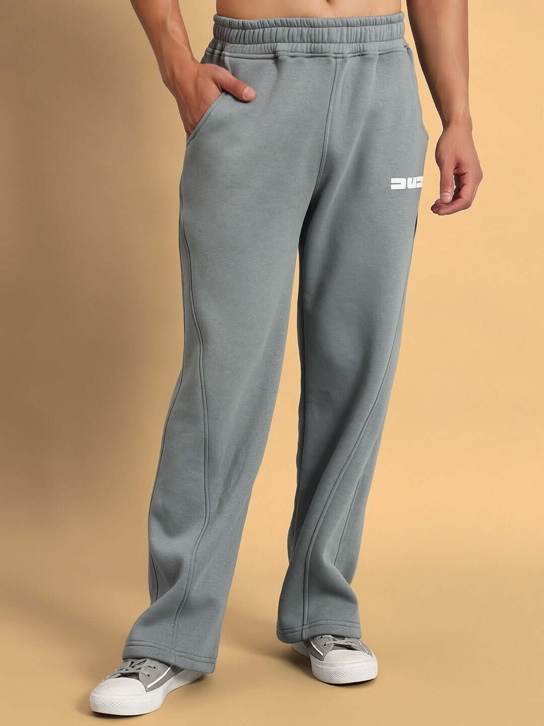 Man wearing SHOOTER COTTON FLEECE PANT GREY, showcasing style and comfort in versatile grey pants for workouts and casual wear.