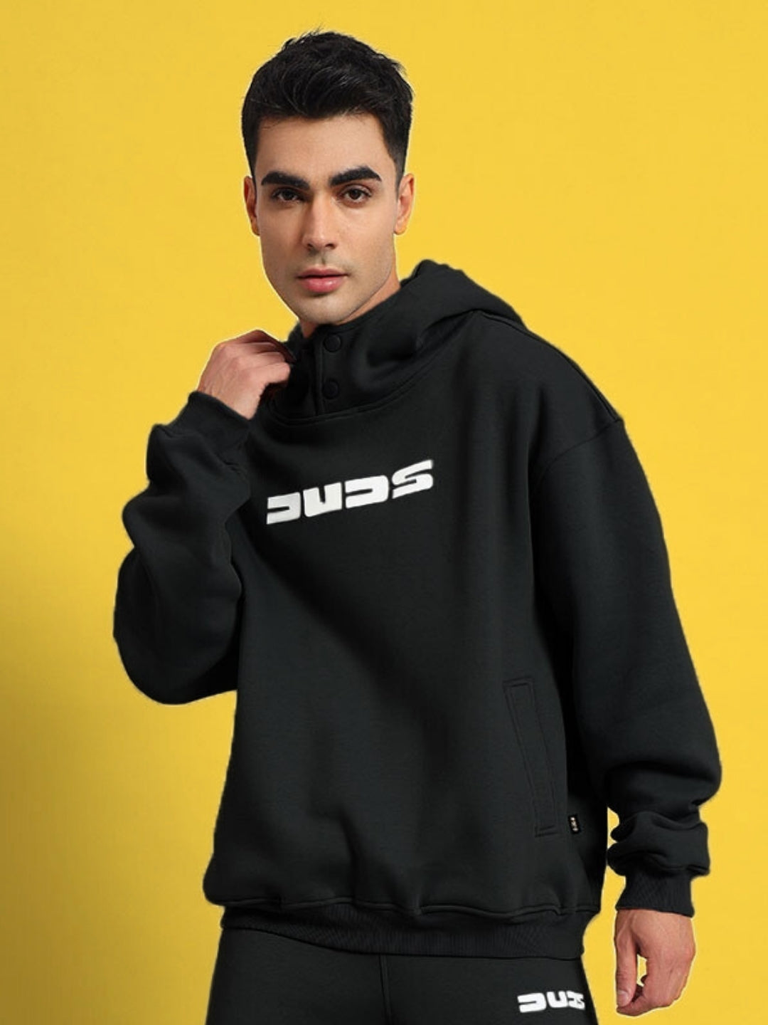Model wearing SHOOTER Cotton Fleece Hoodie in Black by DUDS, made to order with customizable size options.