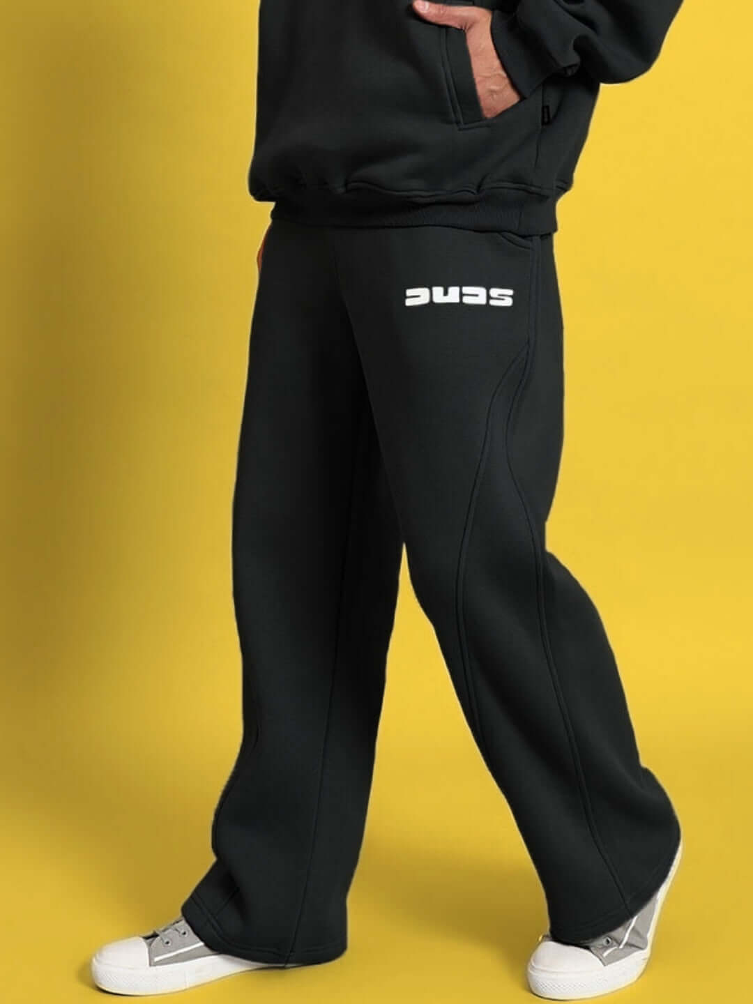Model wearing WEARDUDS SHOOTER FLEECE PANT BLACK, showcasing comfortable fit and style for custom orders made by skilled tailors.