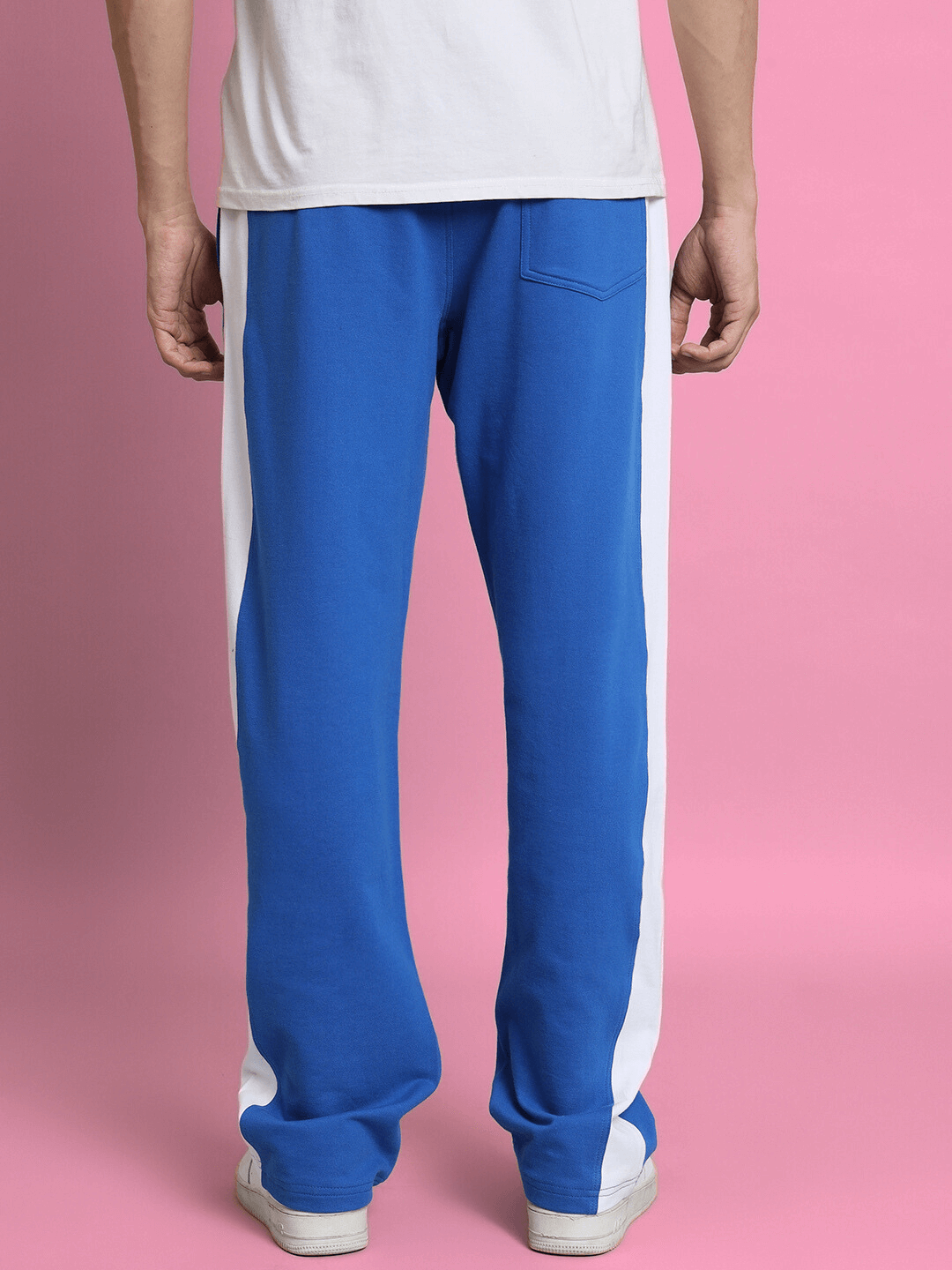 Royal blue joggers with side seams, designed for comfort and style, displayed against a pink background.
