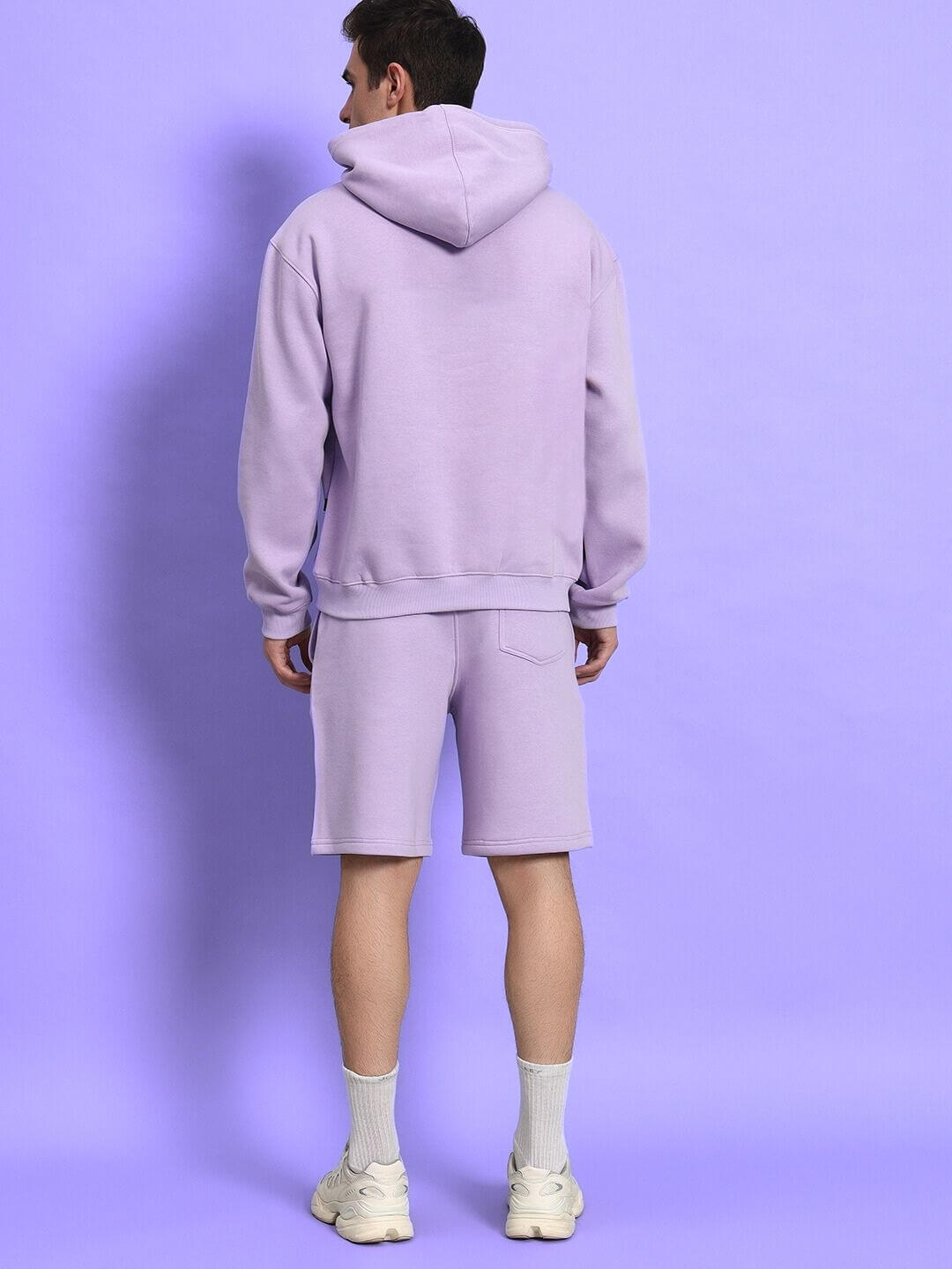 Back view of model wearing SILENT HUG PRINTED FLEECE CO-ORD LILAC in stylish lilac hoodie and shorts set.