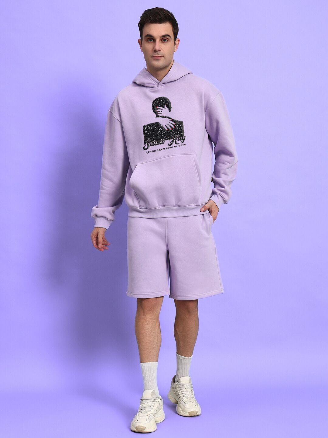 Man wearing SILENT HUG PRINTED FLEECE CO-ORD LILAC set against a lilac background.