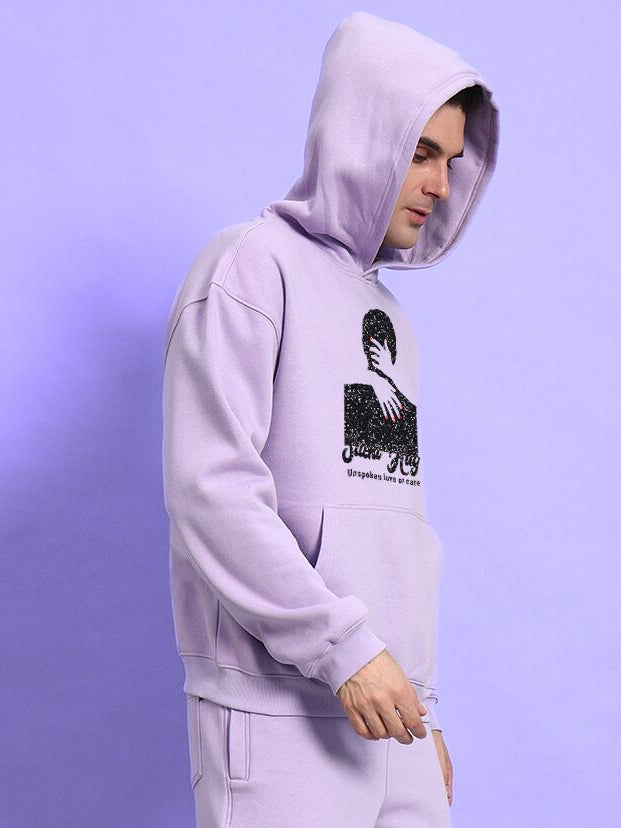 Man wearing SILENT HUG PRINTED FLEECE HOODIE LILAC, showcasing pastel lilac shade with subtle printed design, perfect for cozy comfort.