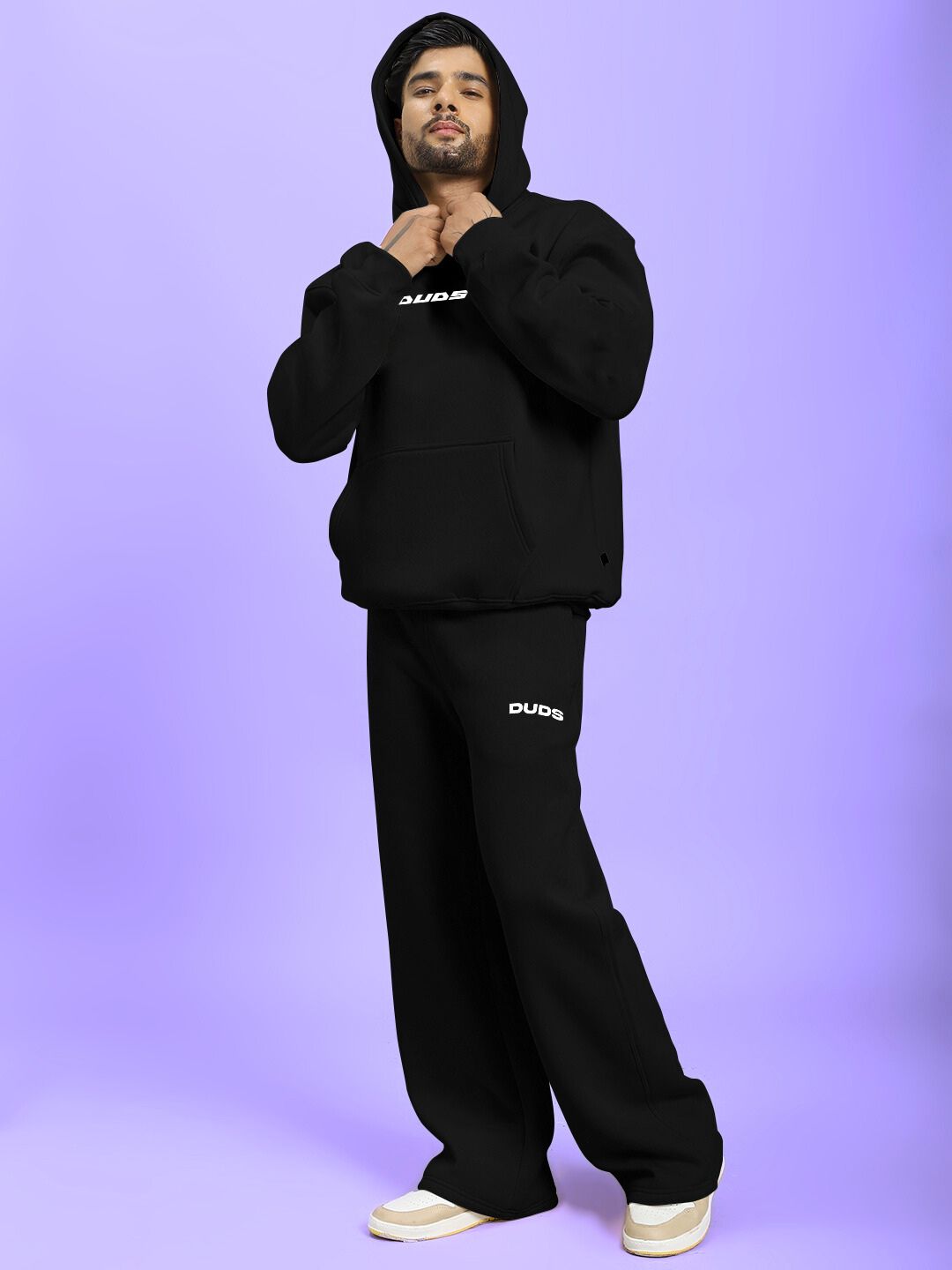 Model wearing SILVER SURFER FLEECE CO-ORD SET BLACK against a light purple background