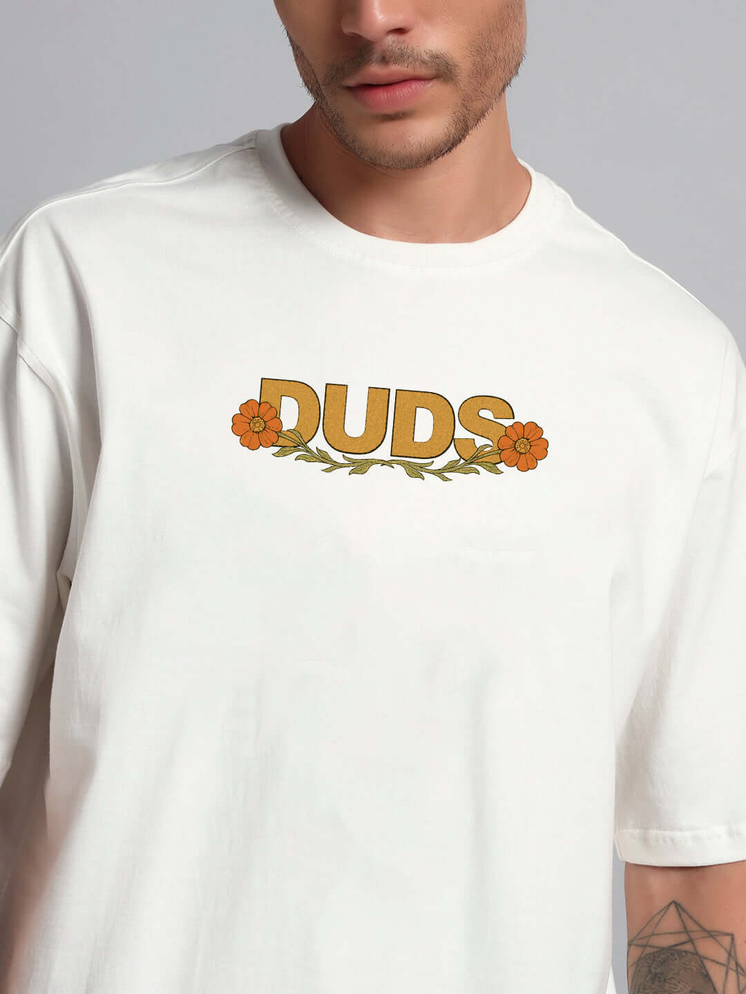 Sitting Lion Oversized T-shirt in off-white, premium cotton with floral DUDS print; comfortable and stylish. Bio-washed fabric.