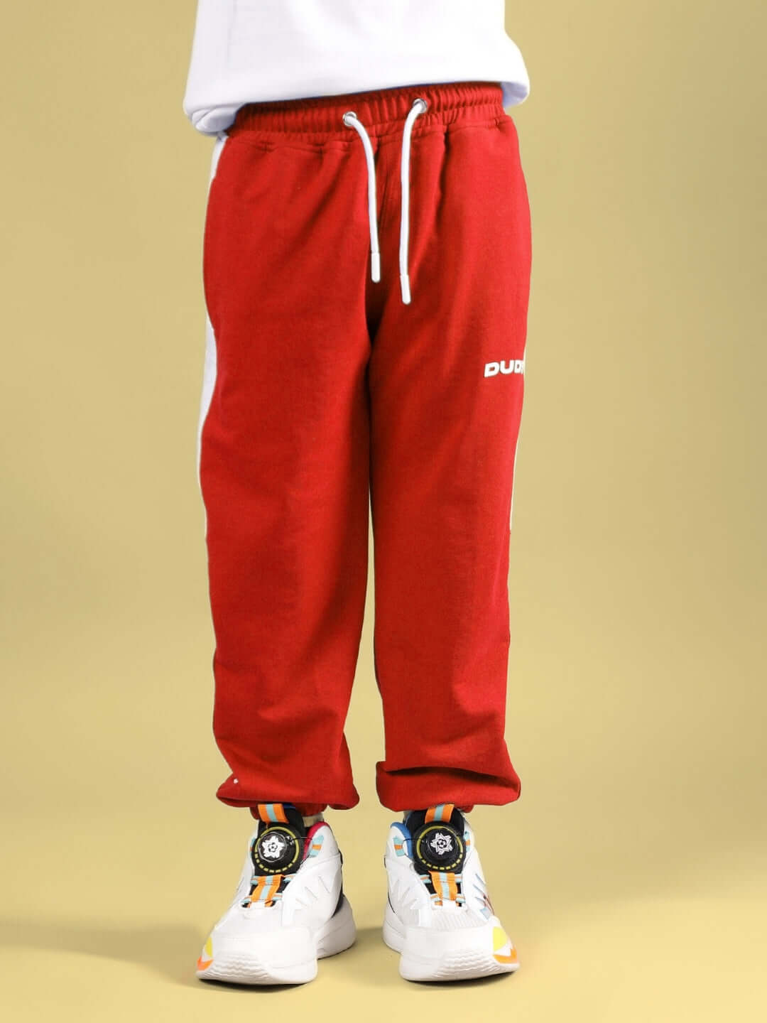 Child wearing SKATER BANANA CO-ORD FOR BOYS & GIRLS WHITE-RED pants, showcasing casual fit.
