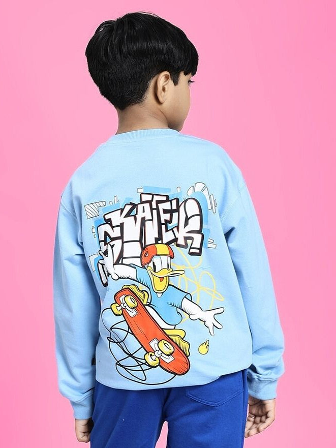 Boy wearing SKATER DUCK SWEATSHIRT FOR BOYS AND GIRLS SKY BLUE with skater duck graphic, pink background