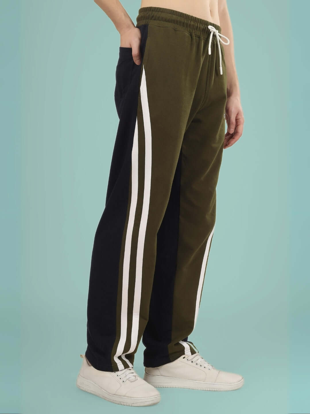 Olive navy skater Korean baggy joggers with white stripes, modeled with white sneakers, featuring adjustable drawstring waist.