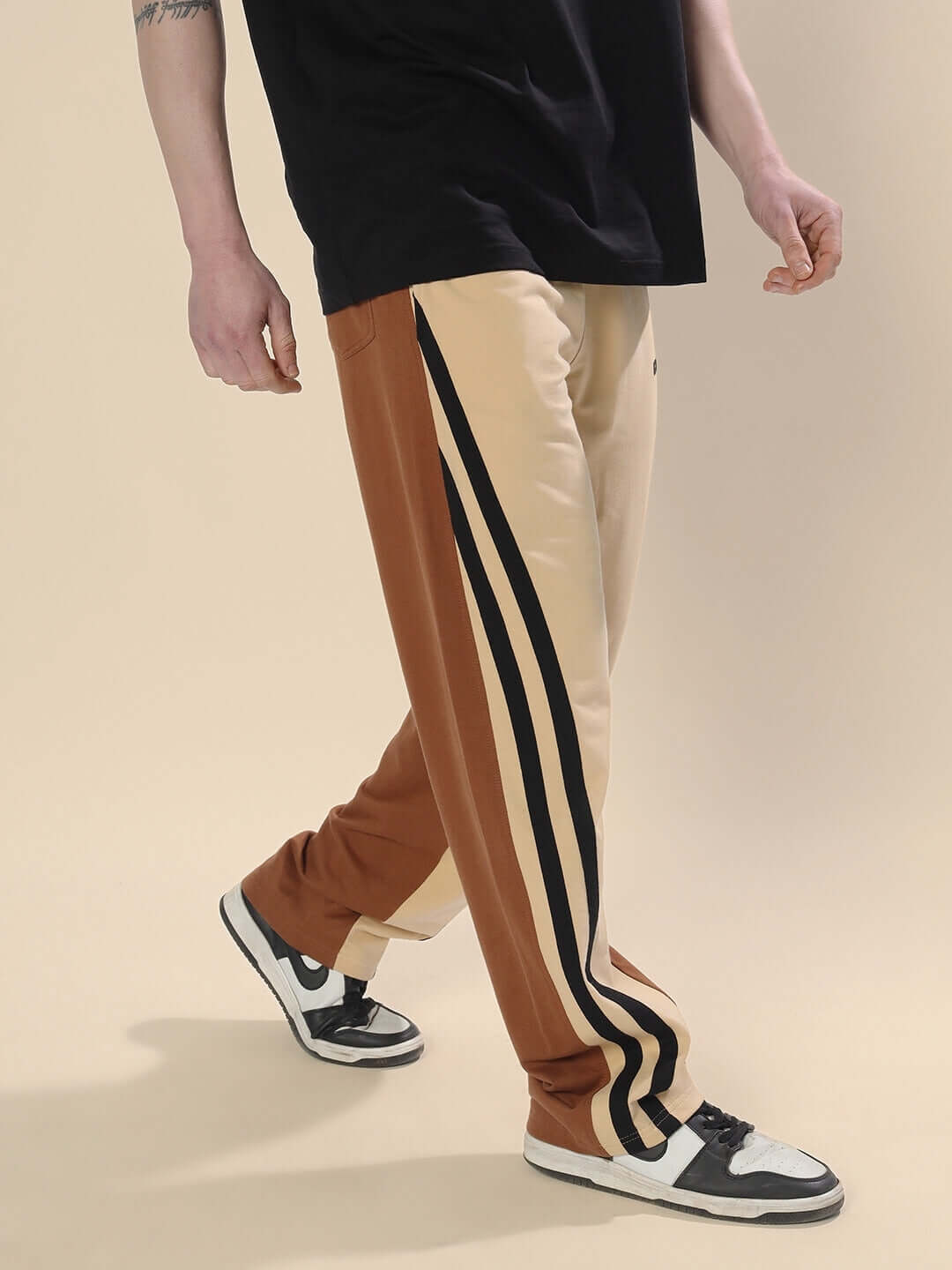 Person wearing SKATER Korean Baggy Joggers in cream brown with stripes, styled with sneakers.