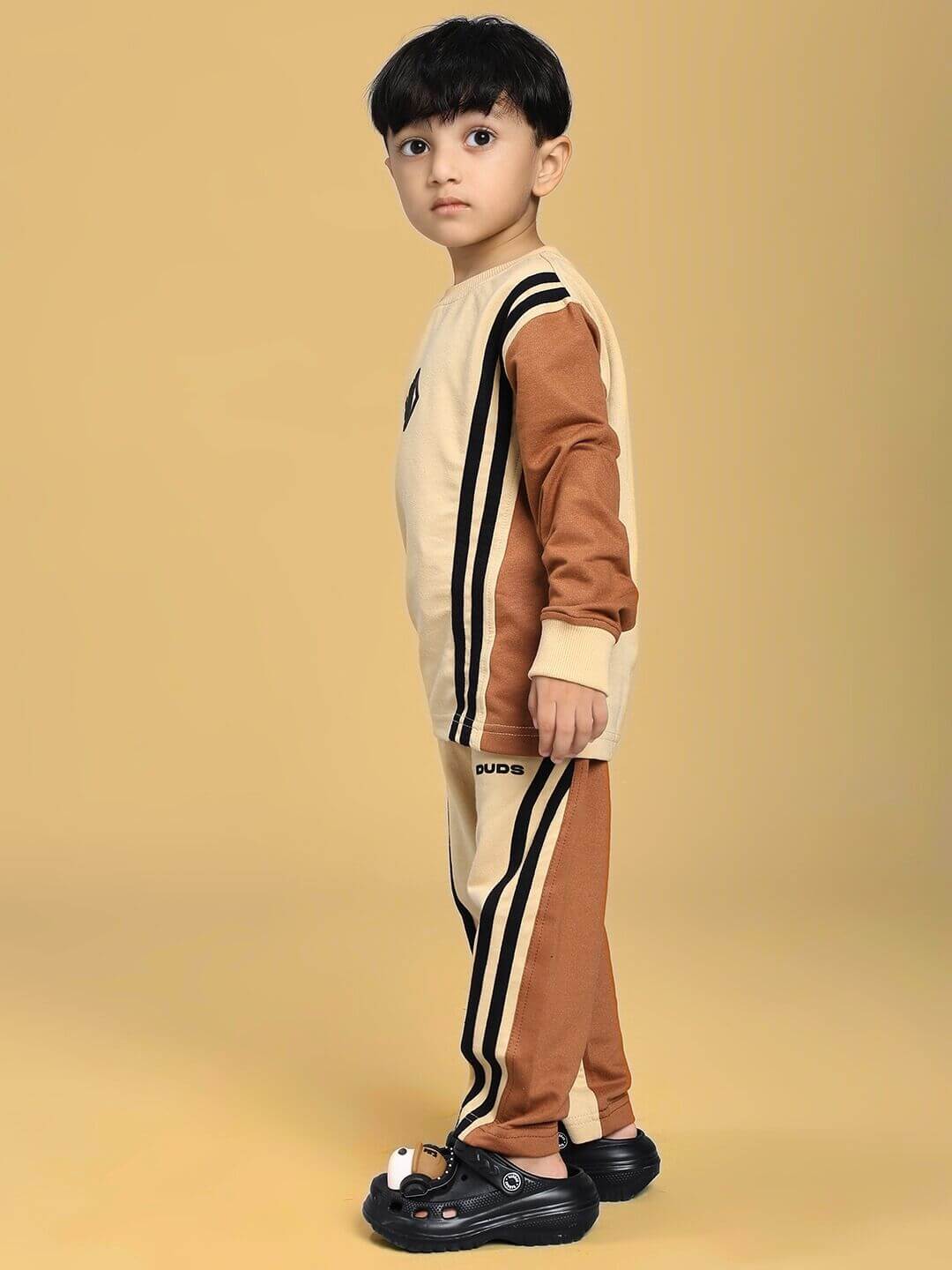 Child wearing SKATER KOREAN CO-ORD FOR BOYS AND GIRLS CREAM BROWN with skater-inspired graphics and cozy design.
