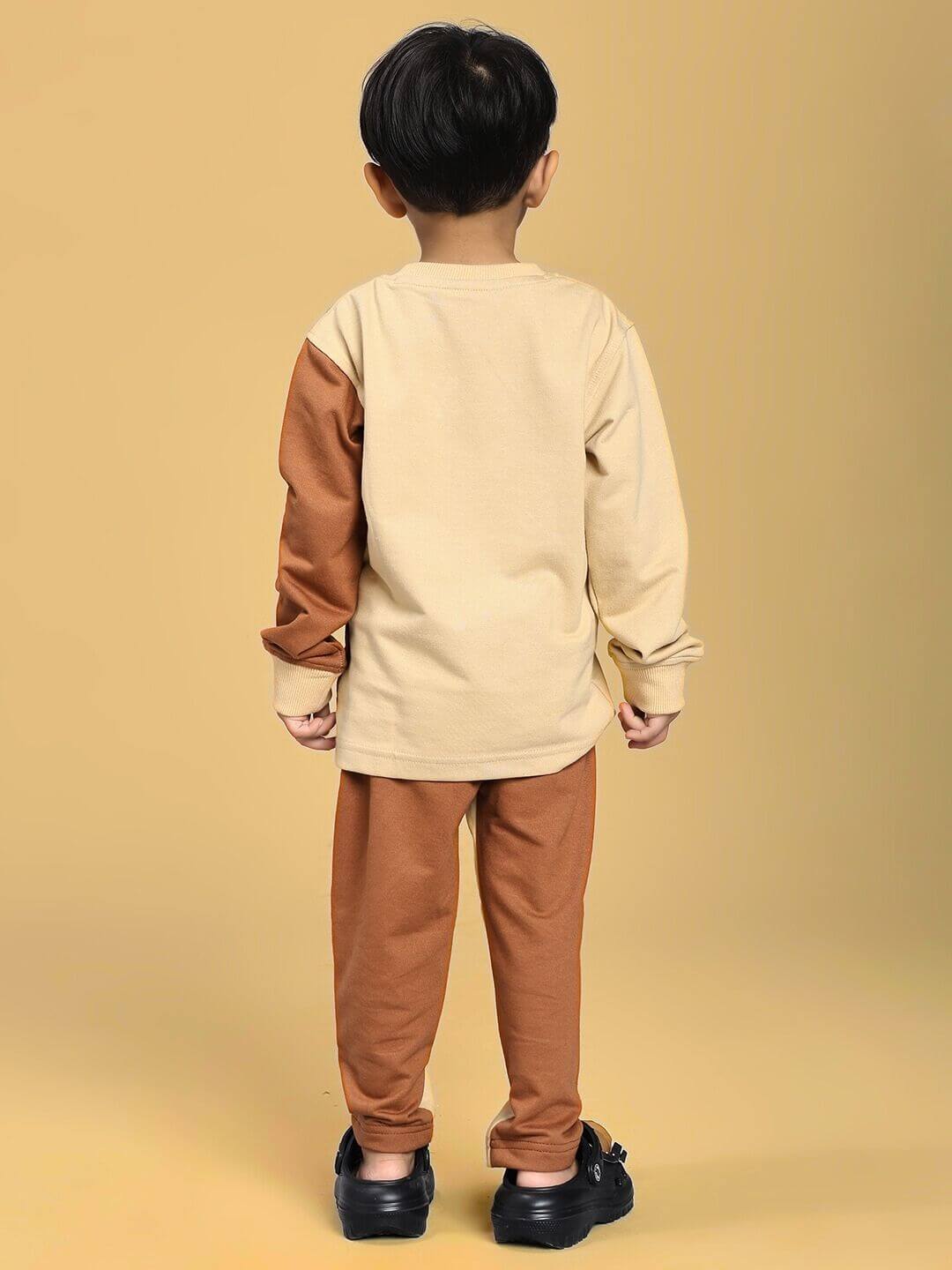 Child wearing SKATER KOREAN CO-ORD FOR BOYS AND GIRLS CREAM BROWN, showing back view with cream top and brown pants.