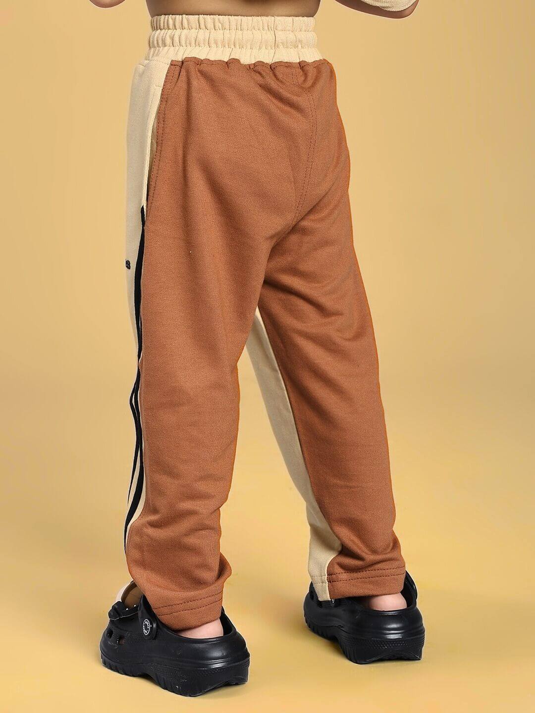 Child wearing SKATER KOREAN JOGGER FOR BOYS AND GIRLS CREAM BROWN, showcasing unique cream-brown style and skater influence.