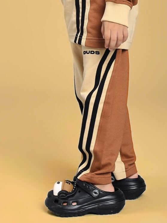 Child wearing SKATER KOREAN JOGGER FOR BOYS AND GIRLS CREAM BROWN with black shoes