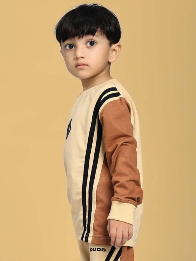 Child wearing SKATER KOREAN SWEATSHIRT BOYS AND GIRLS CREAM BROWN with stripe details, standing against a plain background.