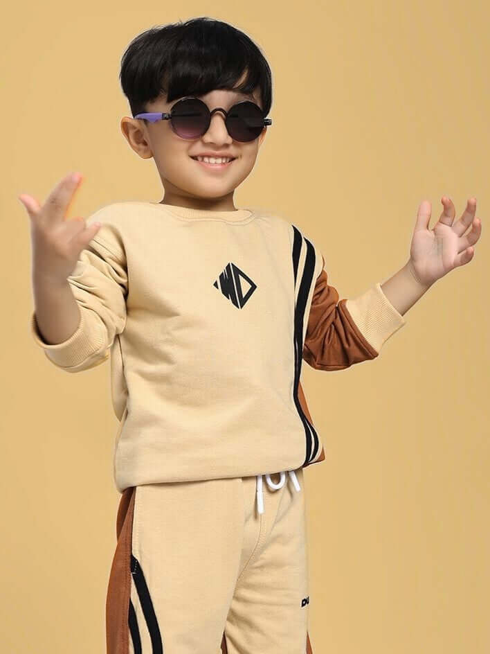 Child wearing SKATER KOREAN SWEATSHIRT BOYS AND GIRLS CREAM BROWN with stylish sunglasses against a beige backdrop.