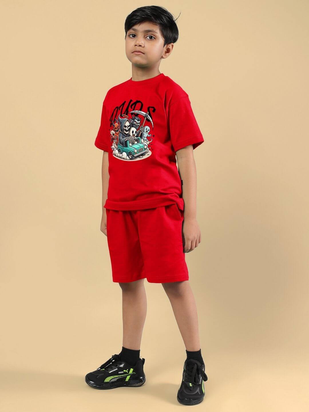 Child wearing SKELETON RIDER CAR PRINT CO-ORD FOR BOYS AND GIRLS RED, a stylish and comfortable outfit in bright red with unique car print design.